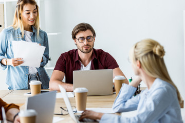 multicultural colleagues working on startup project in office and looking at each other