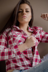 Young brunette woman with black bra posing with open shirt