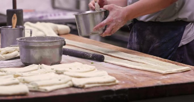 Master making sesame flat bread