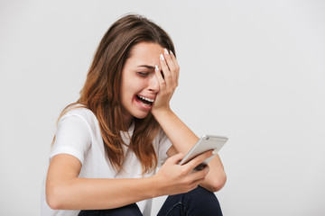 Fototapeta premium Scared crying woman holding mobile phone