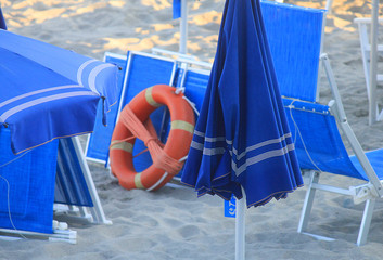 umbrellas, beach chairs and lifebuoy on the beach