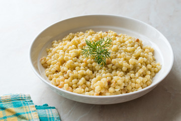 Cooked Couscous with Dill served in White Plate / Turkish Kuskus