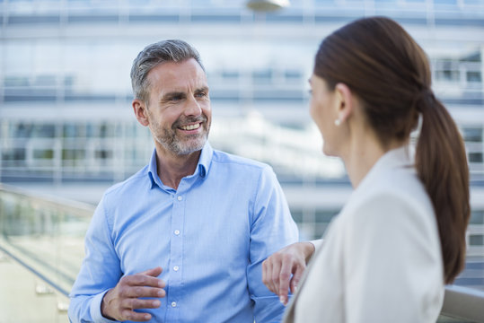 Portrait smiling businessman face to face to his business partner