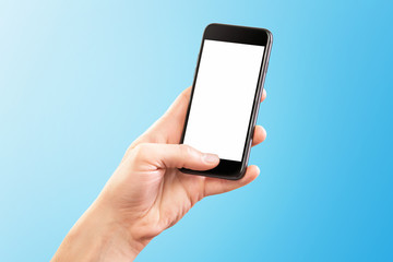 Mockup of male hand holding black cellphone isolated at blue background.