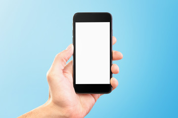 Male hand holding black cellphone isolated at bue background.