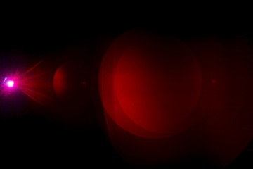 Camera lens flare by laser light create circles of objective and interference effect and moire on digital sensor on dark black background