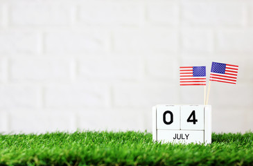 July 04 Wooden calendar and American Flag Concept American national day with space for your text