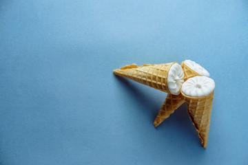 ice cream on a blue background, three wafer horns, top view, place for text