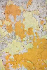 Close-up photo of the old rough weathered colored stucco wall texture