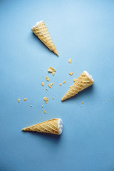 ice cream on a blue background, three wafer horns, bread crumbs, top view,