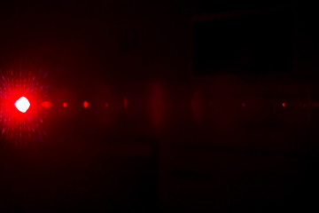 Camera lens flare by laser light create effect depending of iris shapes and interference effect and moire on digital sensor on dark black background