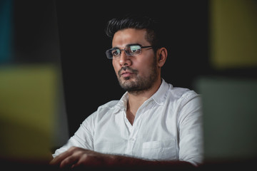 Asian businessman concentrating on working at night
