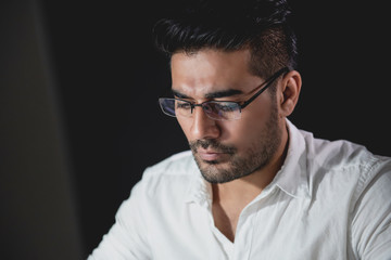 Asian businessman concentrating on working at night