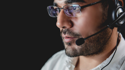 Asian male customer service  operators working night shift in call center