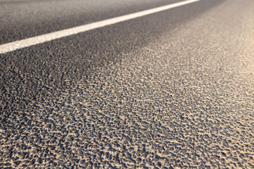 Road marking line on asphalt close-up