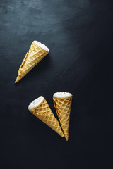 ice cream on a black background, three wafer horns, top view,