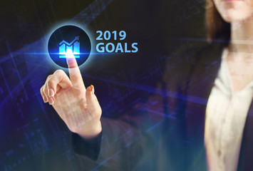 The concept of business, technology, the Internet and the network. A young entrepreneur working on a virtual screen of the future and sees the inscription: 2019 goals