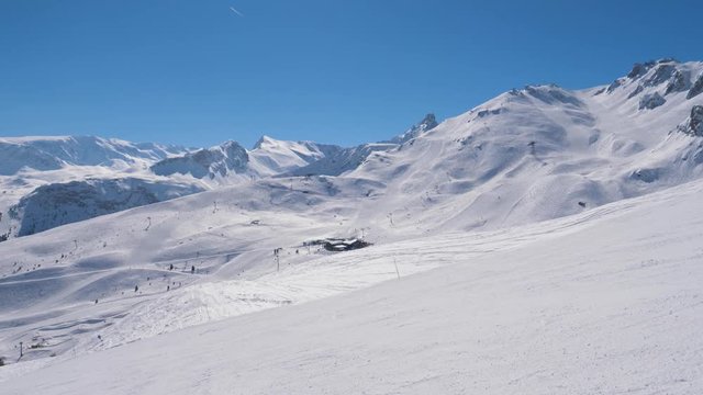 Panning Snowy Mountains At A Ski Resort Many Skiers On The Slope