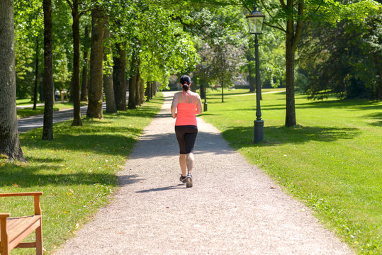 Rear view of a woman running in a park
