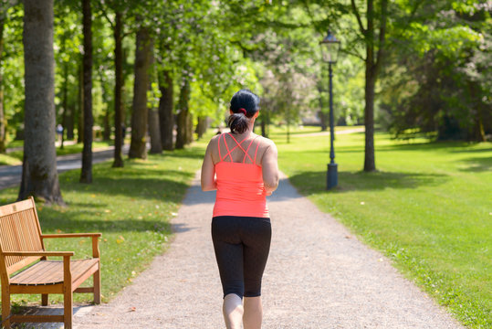 Rear view of a woman running in a park