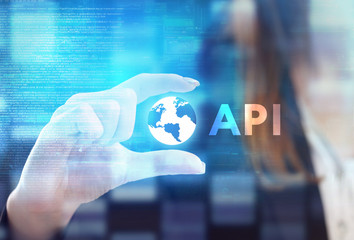 The concept of business, technology, the Internet and the network. A young entrepreneur working on a virtual screen of the future and sees the inscription: API