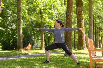 Athletic woman working out in a spring park