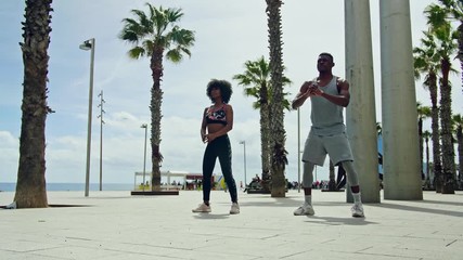 Black couple doing exercise outdoors - Powered by Adobe