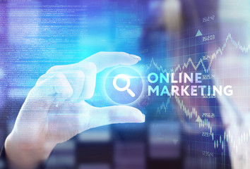 The concept of business, technology, the Internet and the network. A young entrepreneur working on a virtual screen of the future and sees the inscription: Online marketing
