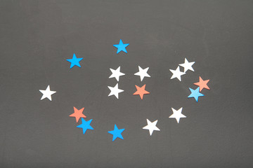 Confetti stars on wooden background. 4th July, Independence day, card, invitation in usa flag colors. View from Top , empty space.