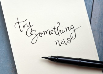 TRY SOMETHING NEW hand-lettered in notepad