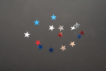 Confetti stars on wooden background. 4th July, Independence day, card, invitation in usa flag colors. View from Top , empty space.