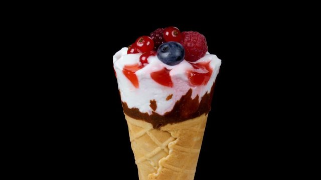 Forest fruits ice cream in cone rotating on black background. 4k