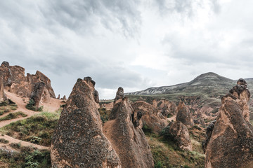 Fototapeta na wymiar majestic geological formations and cloudy sky in cappadocia, turkey