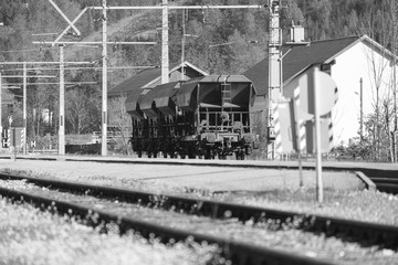 Naklejka na ściany i meble Black and white Bogies on railway through Obertraun village