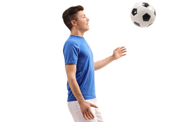 Teenage soccer player with a football