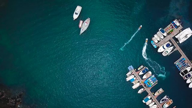 Flight over a dock with a lot of yachts and boats - shooting from a drone