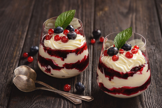 Berry mascarpone mousse dessert, on black background.