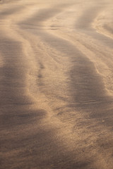 Vertical line Pattern in the mixture of yellow and black sand, Costa Adeje, Tenerife, Canary Islands, Spain