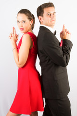 young fashion couple on a white background in studio posing like for movie poster