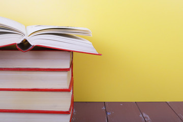 Science and education -  fragment group of red books empty open top on the wooden table