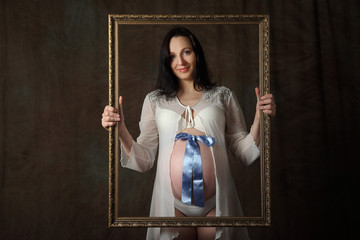 Pregnant belly with blue ribbon