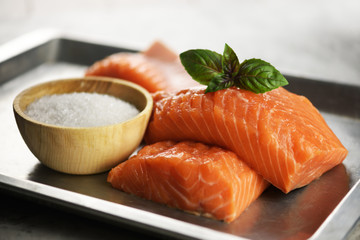 Fillet of salmon fish on metal plate closeup. Food photography
