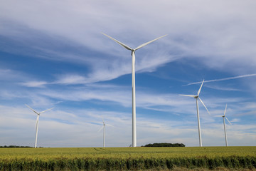 A wind farm in a field in the countryside