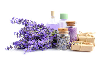 Spa products and lavender flowers on a white background