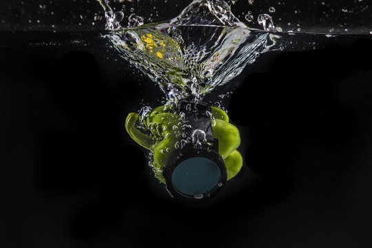 Bell pepper splashing in water with smartwatch