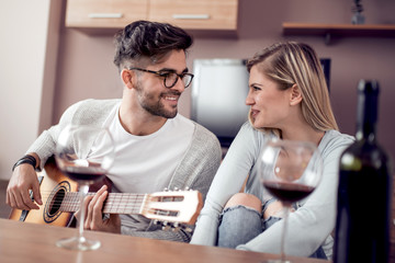 Happy lovely couple drink red wine