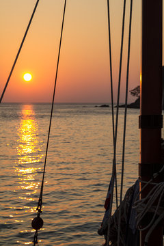 Silhouette of a wooden sailing boat mast and rigging in the sunset in the Andaman sea in Thailand