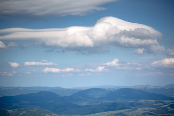 Clouds of unusual shape over the mountain range.
