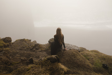Woman in black dress in the fog in iceland