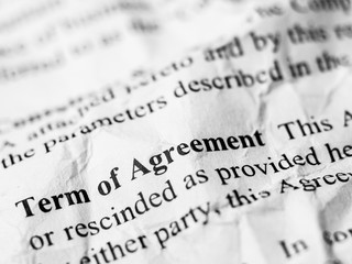 Term of Agreement word message on crumpled and wrinkled contract paper
